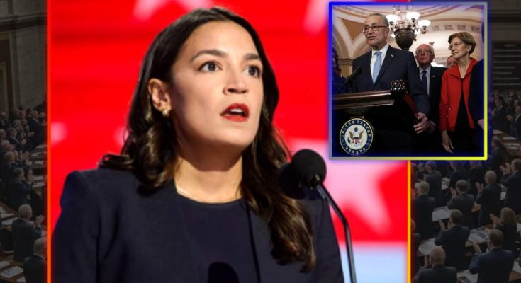A woman speaking at a podium in a large chamber with people seated in rows behind her