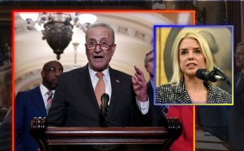 A man in a suit speaking at a podium with the United States seal, alongside a smaller