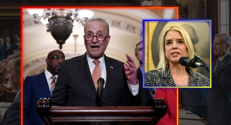 A man in a suit speaking at a podium with the United States seal, alongside a smaller