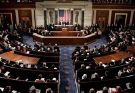 Interior view of a large legislative chamber with many people seated in rows, an