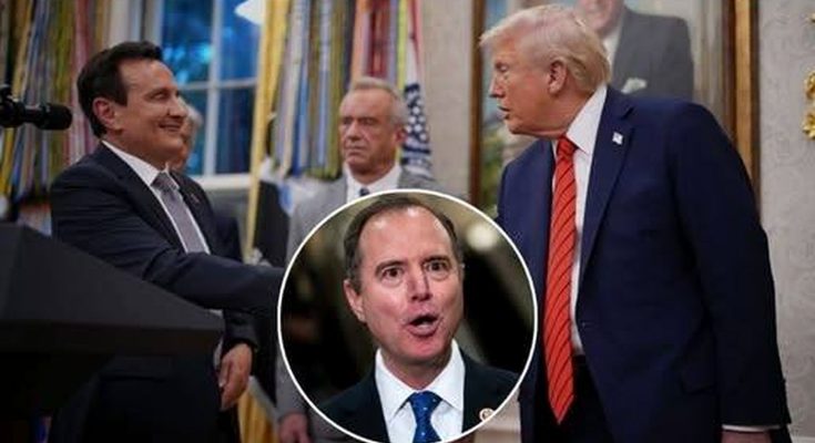 Donald Trump in a blue suit and red striped tie shaking hands with a man in a dark suit