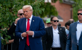 Donald Trump walking outdoors with security detail
