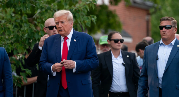 Donald Trump walking outdoors with security detail