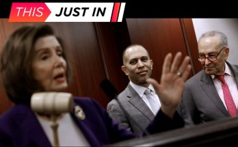 Nancy Pelosi speaking at a podium with a gavel, with Hakeem Jeffries and Chuck Schumer