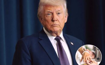 Donald Trump in a dark blue suit with a patterned tie, standing against a dark blue