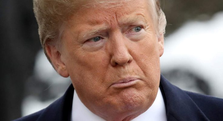 Close-up portrait of Donald Trump wearing a dark suit, white shirt, and red tie, with