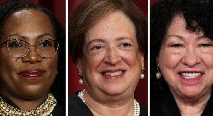 Three women in formal attire with jewelry, side by side against a red background