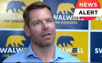 Eric Swalwell speaking in front of campaign signs with a bear logo, with a news alert