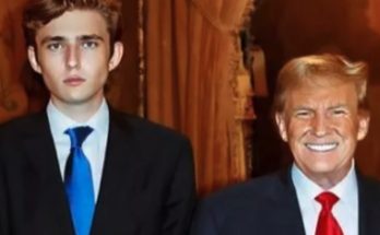 Two men in suits standing side by side, one with a blue tie and one with a red tie, in