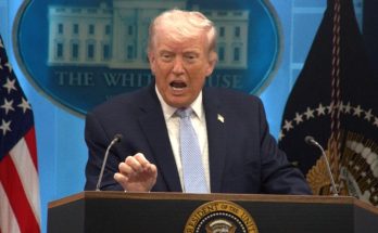 Donald Trump speaking at a White House podium with American flags behind him