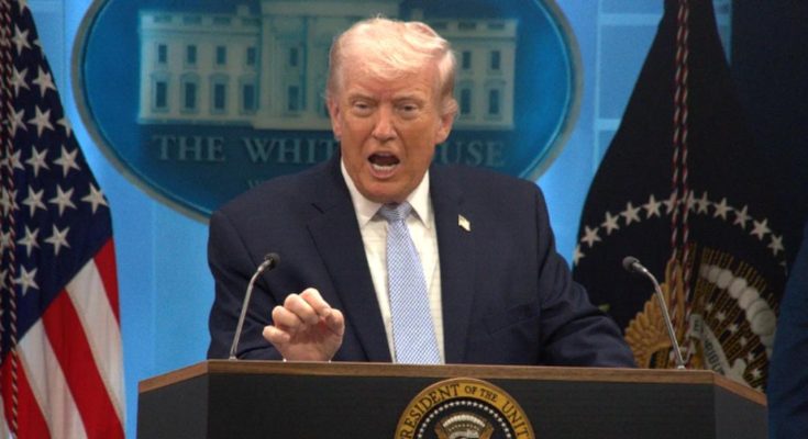 Donald Trump speaking at a White House podium with American flags behind him