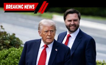 Donald Trump and J.D. Vance standing outdoors, both wearing dark suits with red ties