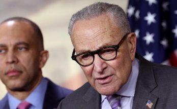 Chuck Schumer speaking at a podium with Hakeem Jeffries standing behind him, American