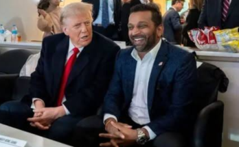 Kash Patel sitting with Donald Trump smiling