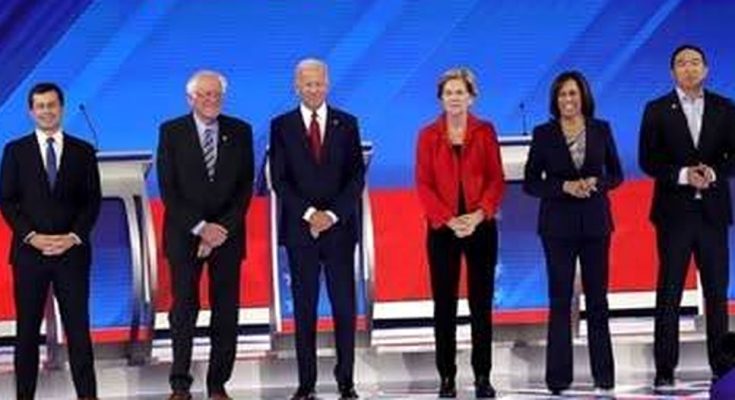 political debate stage with eight candidates standing, blue and red backdrop