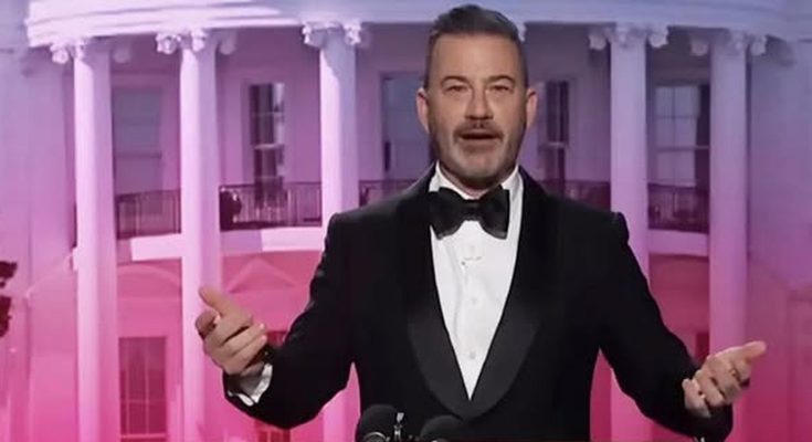 host in tuxedo at White House Correspondents' Dinner podium