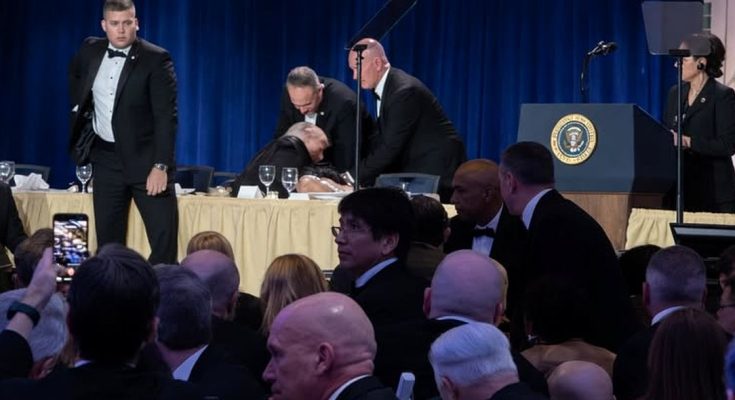 event audience watches emergency response on stage during speech