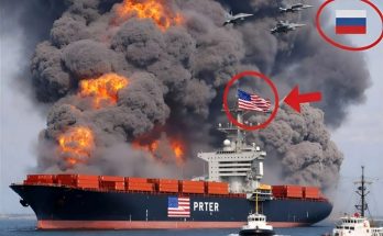 cargo ship engulfed in flames with military jets overhead