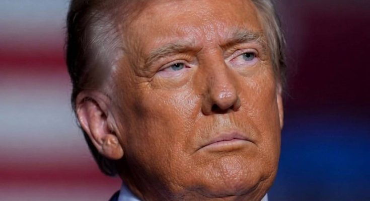 serious man in suit with flag background, focused expression
