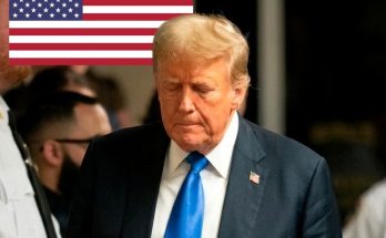 donald Trump walking through courthouse corridor with American flag and conviction