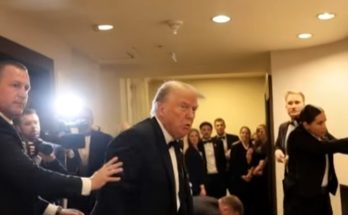 security team escorts man in tuxedo during high-profile event