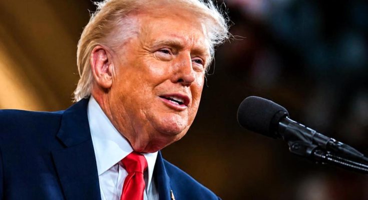 man speaking into microphone at a formal event