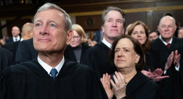 chief Justice Roberts and Supreme Court justices applauding in black robes with headline