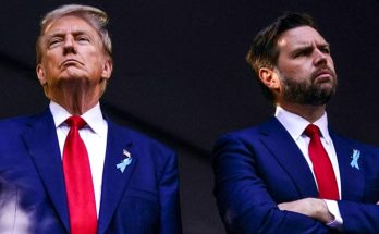 donald Trump and JD Vance stand side by side in matching navy suits, red ties, and blue