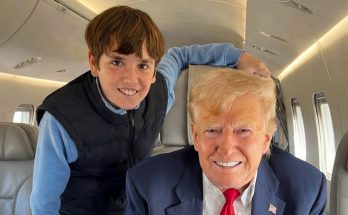smiling man and young boy on private jet interior