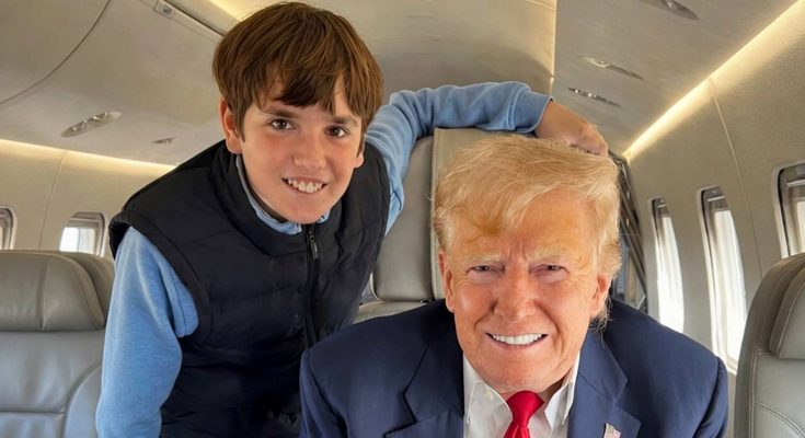 smiling man and young boy on private jet interior
