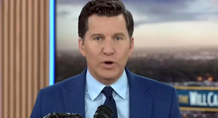 news anchor in blue suit delivering headline on camera