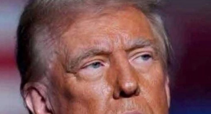 close-up portrait of Donald Trump with serious expression against blurred red and blue