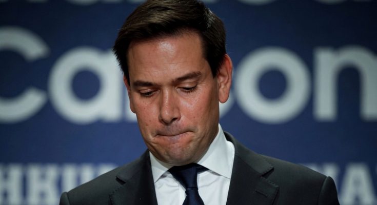 man in suit with thoughtful expression, blue background