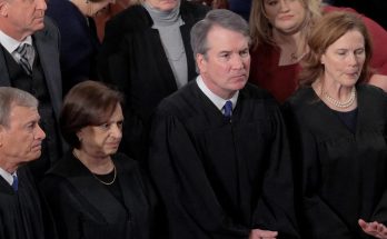 judges in robes standing solemnly at an official event