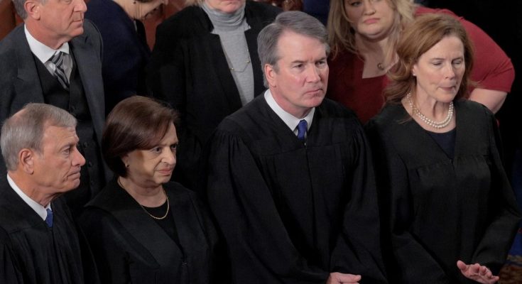judges in robes standing solemnly at an official event