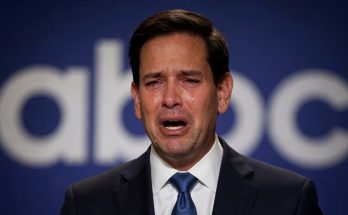 man in a suit crying on stage with ABC logo behind him