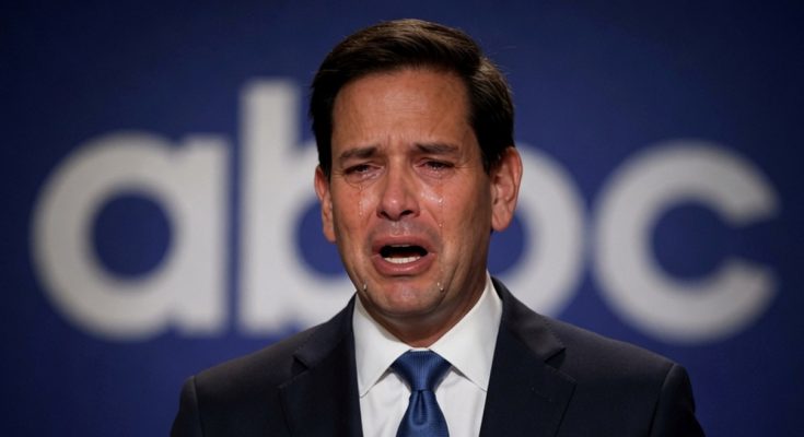 man in a suit crying on stage with ABC logo behind him