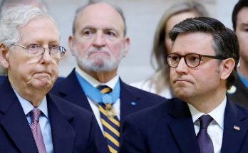 mitch McConnell and Speaker Mike Johnson stand together at a formal event with Medal of
