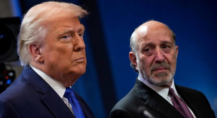 two men in suits at a formal event, serious expressions