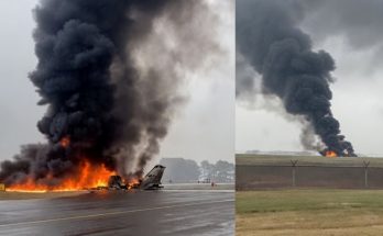 airplane engulfed in flames on runway with thick smoke rising