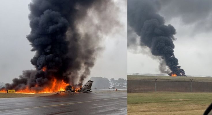 airplane engulfed in flames on runway with thick smoke rising