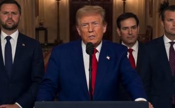 political leaders at podium with Iranian flags and protest
