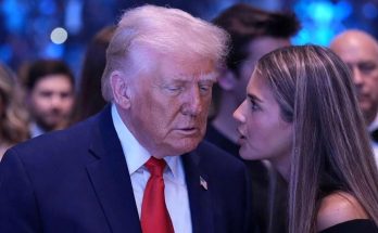 l8BXLF speaking in a news photo