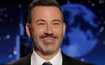 smiling TV host in suit with breaking news alert