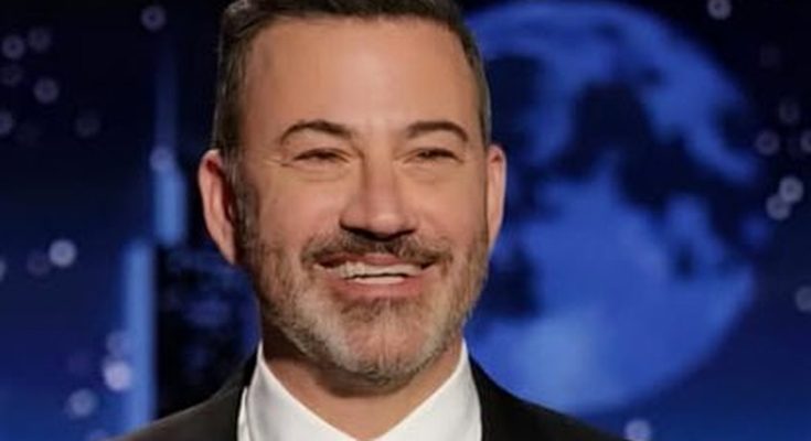 smiling TV host in suit with breaking news alert