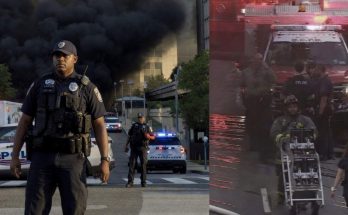 police and firefighters respond to city building fire, heavy smoke visible