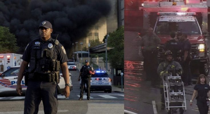 police and firefighters respond to city building fire, heavy smoke visible