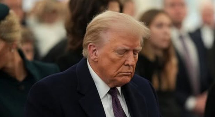 serious man in suit amid crowd at formal event