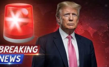 man in suit with red alert symbol and breaking news banner
