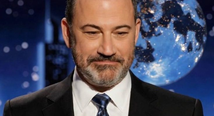 smiling man in suit with moon backdrop on TV set